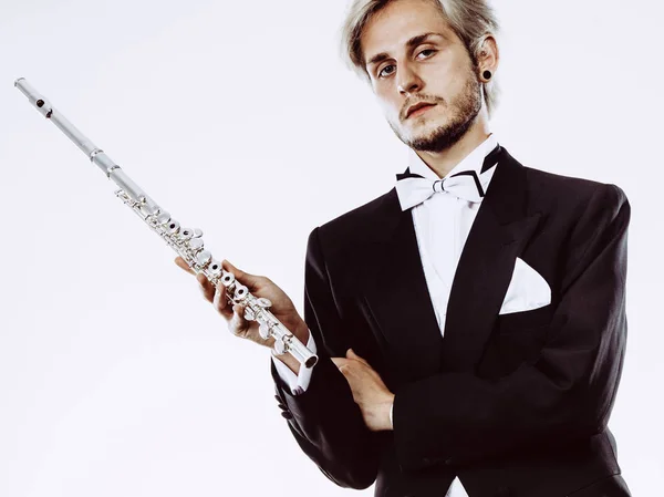 Male flutist wearing tailcoat holds flute — Stock Photo, Image