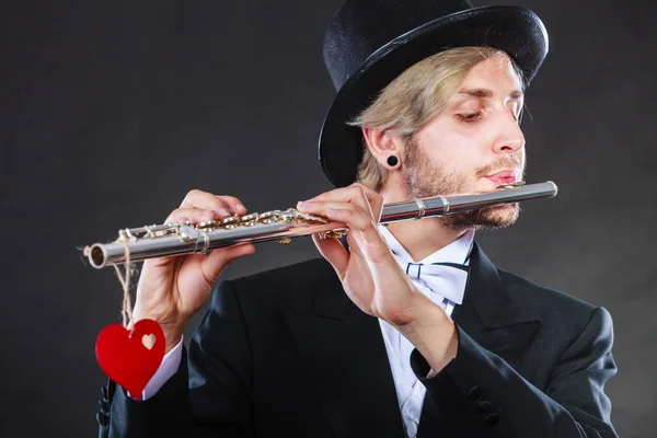 Male flutist with flute and heart. Love melody — Stock Photo, Image