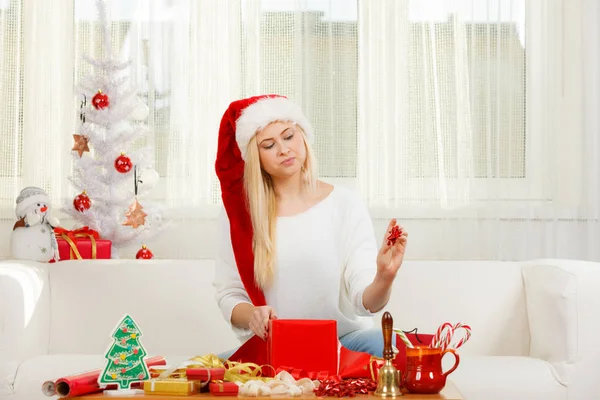 Young woman preparing gifts for Christmas
