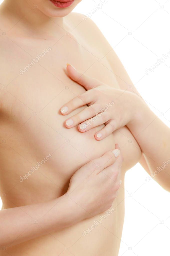 Woman examining her breasts for breast cancer