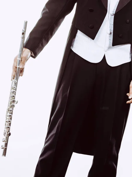 Male flutist wearing tailcoat holds flute — Stock Photo, Image