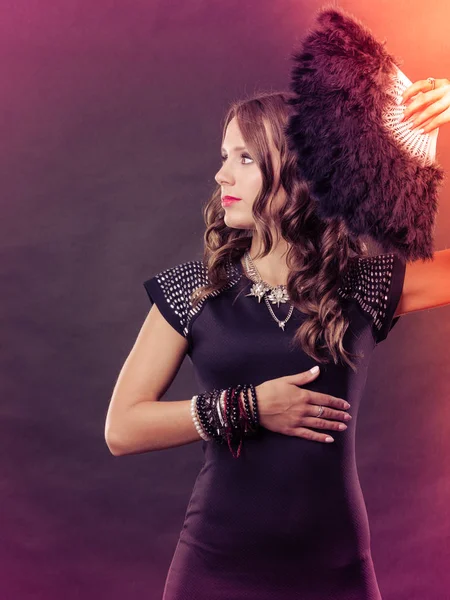 Beautiful brunette woman with black fan in hand — Stock Photo, Image