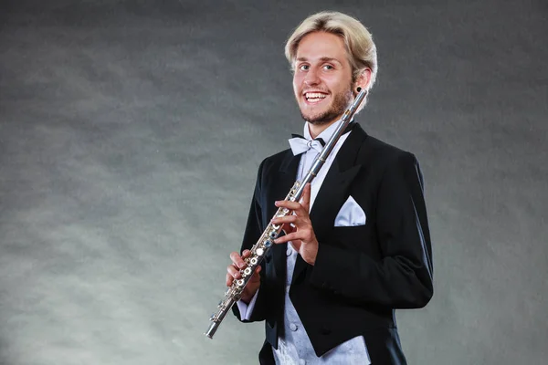 Elegantly dressed musician holding flute — Stock Photo, Image