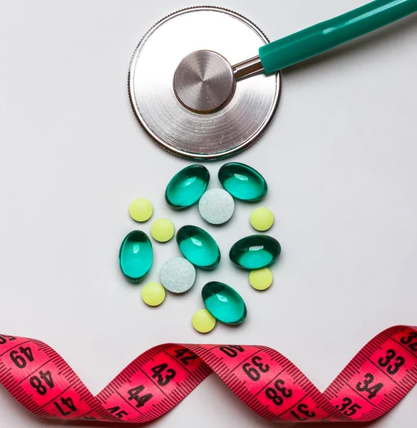 Pills stethoscope measuring tape on table. Health care — Stock Photo, Image