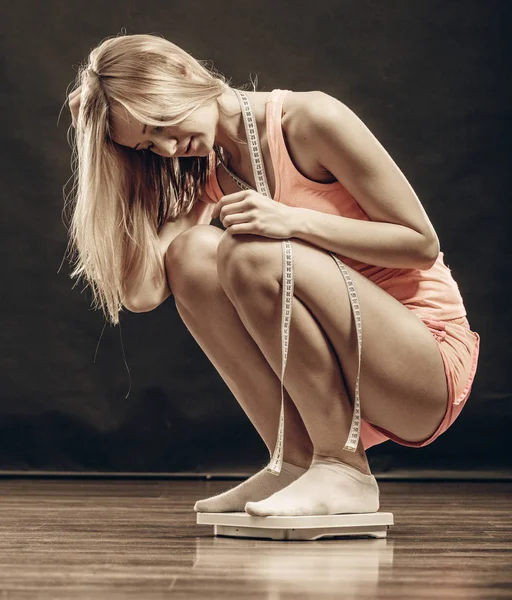 Gymnase femme sur l'échelle de poids — Photo