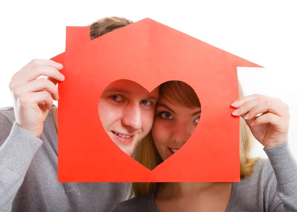 Young cheerful couple holding house. Royalty Free Stock Images