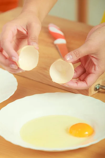 Woman hands with egg in a kitchen