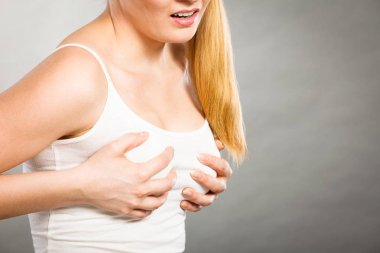 Woman suffering from breast pain clipart