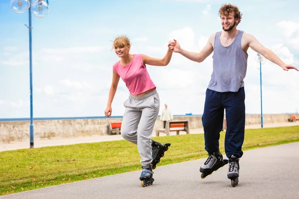 Active people friends rollerskating outdoor.