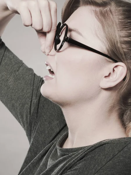 Girl pinches her nose because of stench stink. — Stock Photo, Image