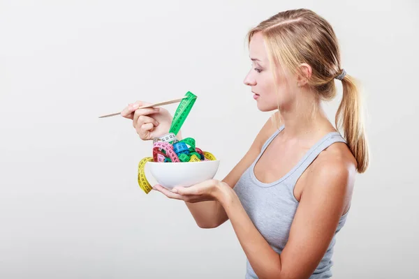Diety. Dziewczyna z kolorowe taśmy pomiarowe w misce — Zdjęcie stockowe