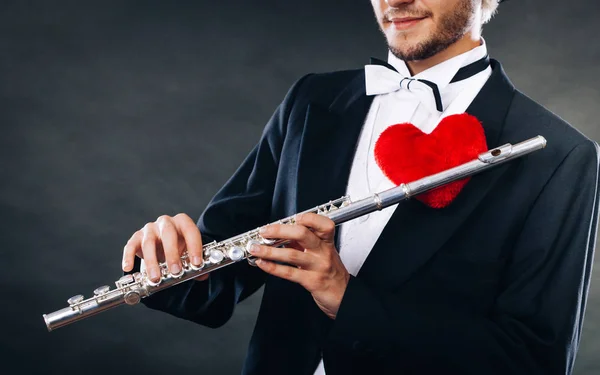 Male flutist with flute and heart. Love melody — Stock Photo, Image