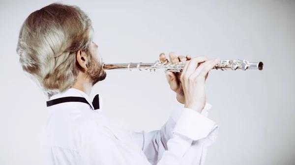 Male flutist playing his flute — Stock Photo, Image