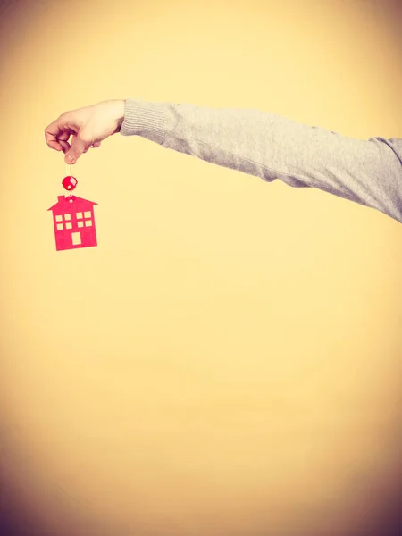 Male hand holding key with house symbol — Stock Photo, Image