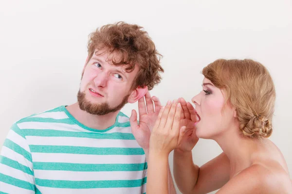 Woman telling an astonished man some secrets — Stock Photo, Image