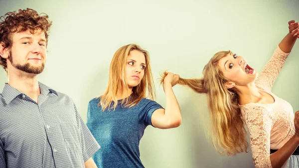 Aggressive mad women fighting over man. — Stock Photo, Image