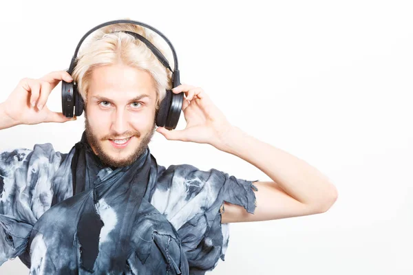 Cool guy having fun listens to music in headphones — Stock Photo, Image