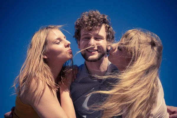 Dos chicas besando a un chico divirtiéndose al aire libre —  Fotos de Stock