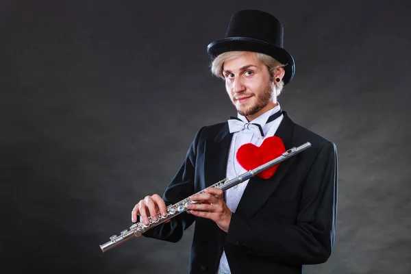 Male flutist with flute and heart. Love melody — Stock Photo, Image