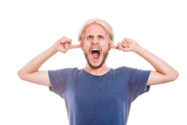Angry man closing ears with fingers — Stock Photo, Image