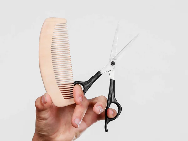 Male hand with scissors and comb — Stock Photo, Image