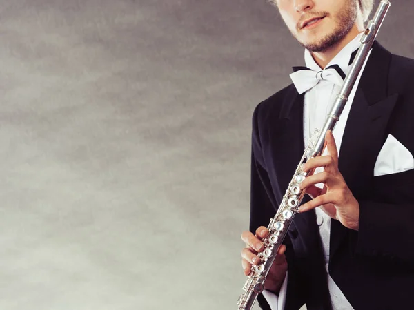 Elegantly dressed musician holding flute — Stock Photo, Image