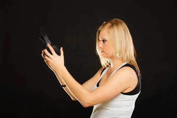 Blonde woman holding big headphones in studio Stock Picture