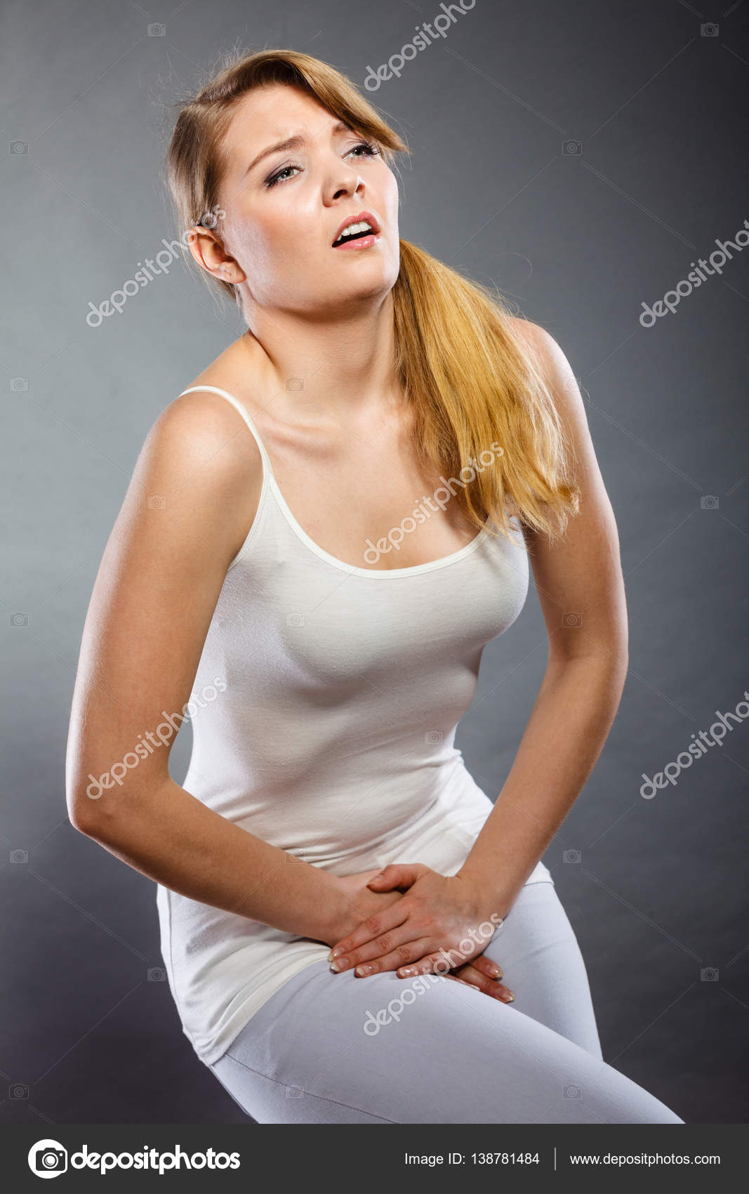 Woman with hands holding her crotch Stock Photo by ©Anetlanda 138781484