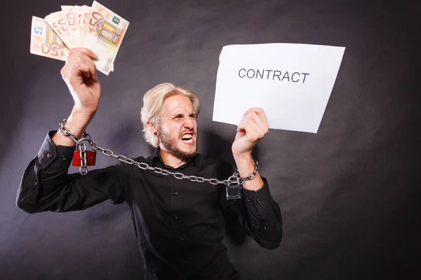 Man met geketende handen met contract en geld — Stockfoto