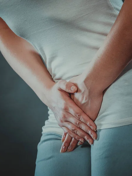 Woman with hands holding her crotch — Stock Image Woman with hands holding her crotch Royalty Free Stock Photos