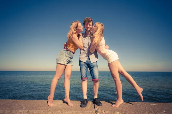 Two girls kissing one boy having fun outdoor — Stock Photo, Image