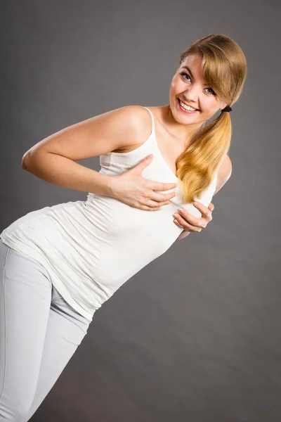 Glada kvinna som håller händerna på hennes bröst — Stockfoto