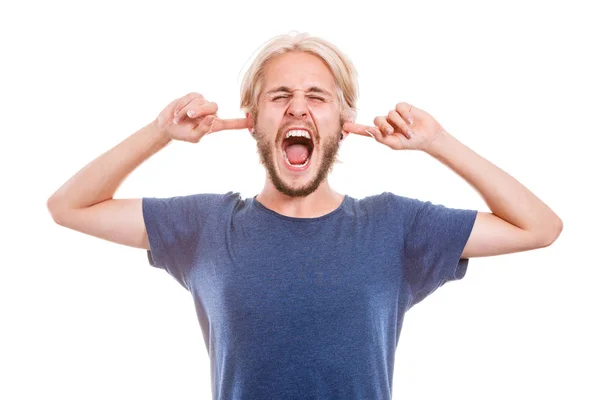 Angry man closing ears with fingers — Stock Photo, Image