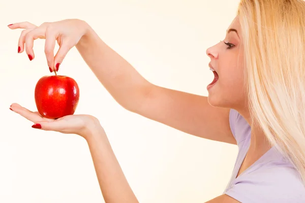 Happy woman holding delicious red apple — Stock Photo, Image