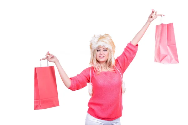 Woman in furry winter hat holding shopping bags — Stock Photo, Image