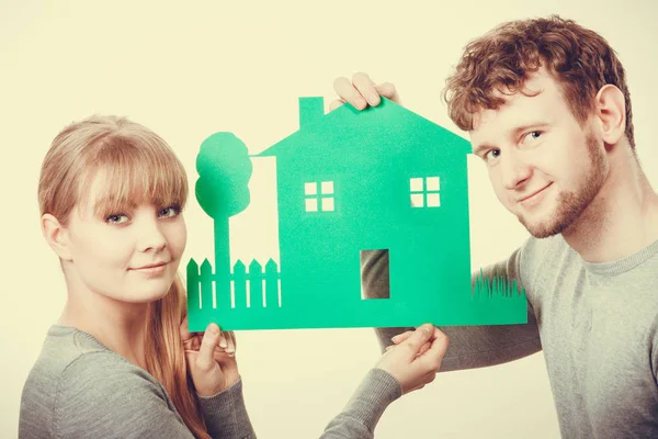 Young couple with ecological green house. — Stock Photo, Image