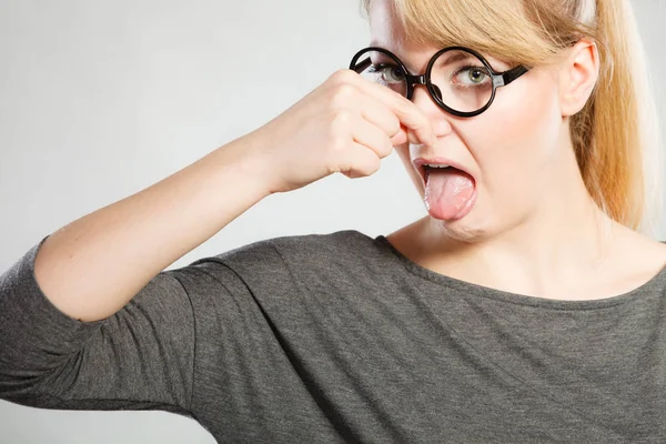 Nerdy girl holding nose. — Stock Photo, Image