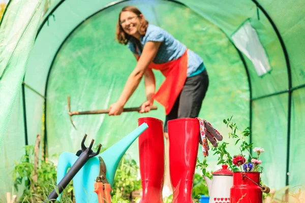 Agricultor feminino e ferramentas de jardinagem no jardim — Fotografia de Stock