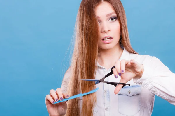 Подготовленная девушка, чтобы обрезать ее длинные прямые волосы . — стоковое фото