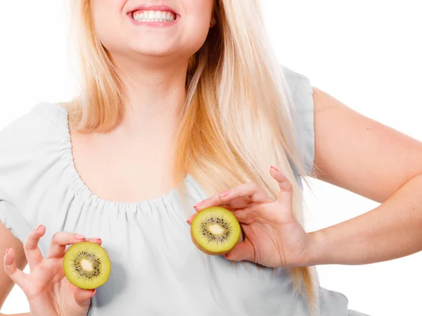 Woman holding green kiwi on breast — Stock Photo, Image