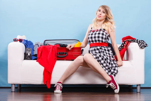 Woman choosing things to pack into suitcase — Stock Photo, Image