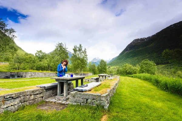 Mujer viajera almorzar en la naturaleza en montañas noruegas — Foto de Stock