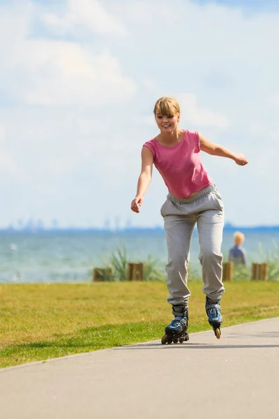 Girl skating alone on seafront. Royalty Free Stock Photos