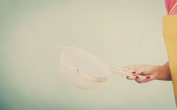 Woman wearing apron holding colander — Stock Photo, Image