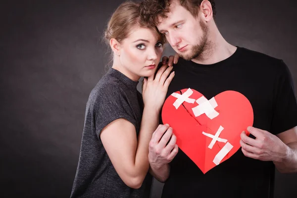 Triste pareja sostiene corazón roto . — Foto de Stock