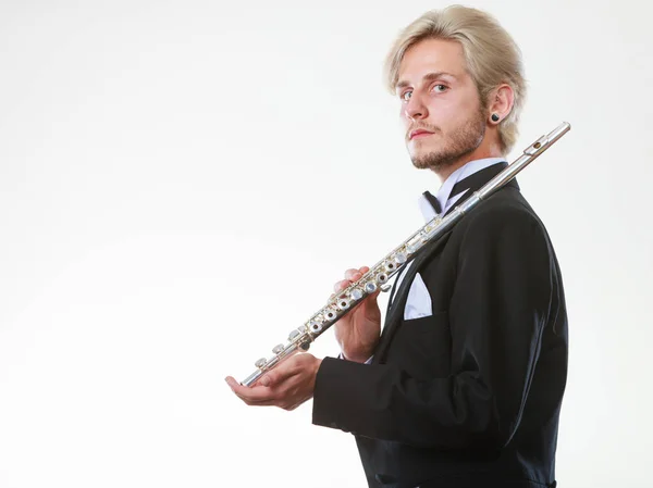 Male flutist wearing tailcoat holds flute — Stock Photo, Image