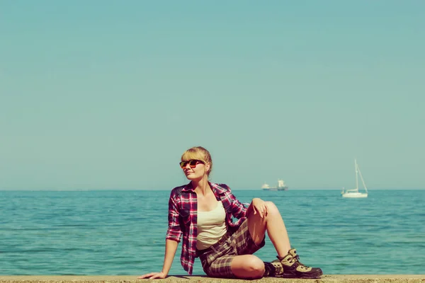 Woman hiker relaxing on sea coast — Stock Photo, Image