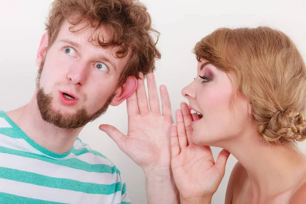 Woman telling an astonished man some secrets — Stock Photo, Image