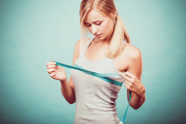 Fitness girl measuring her breasts — Stock Photo, Image