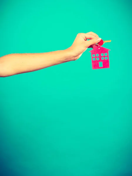 Person holding keys with pendant in house shape — Stock Photo, Image